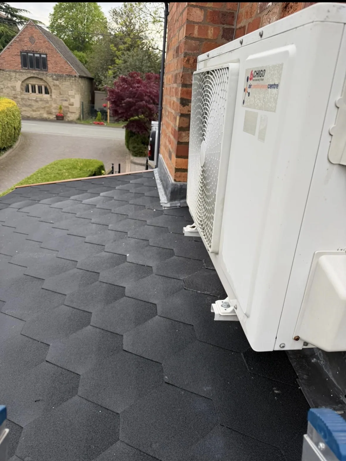 Air conditioning condenser on a flat roof at a property in the West Midlands